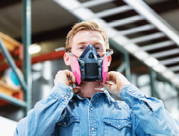 Worker wearing a half face respirator